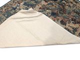 a close up of a rug on a white surface with a blue border