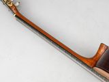 underside view of a guitar with a wooden body and neck rest