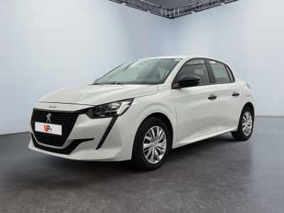 Une voiture blanche est garée dans une pièce blanche au sol noir.