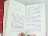 a person holding an open book in their hand