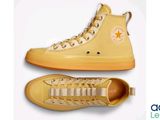 yellow converses with white laces and a star on the side