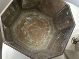 a metal bowl sitting on top of a white toilet