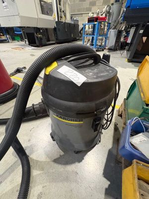 a vacuum that is sitting on the floor in a room