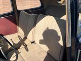 a picture of a car with a dog sitting in the back seat