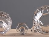 three crystal vases sitting on a table next to each other