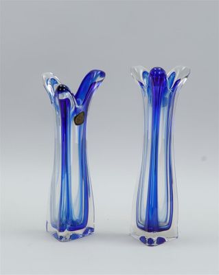 pair of blue and white glass vases sitting on top of a table