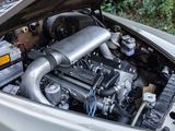 a silver car with a large engine in the trunk