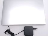 a laptop with a charger attached to it on a table