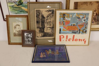 many framed pictures on a table with a picture of a man