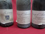 several bottles of wine are lined up on a red table