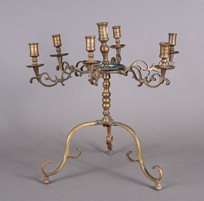 a brass candelab with four candles on it