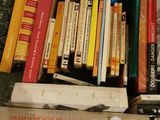 a box full of books on a table with a pair of scissors