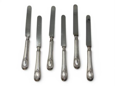 four silverwares with a knife and a fork on a white surface