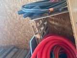 a pile of hoses sitting on the floor next to a pile of wood