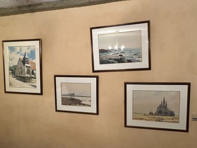 four framed pictures on the wall of a room