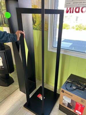 a man that is standing next to a tall speaker