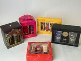 four different types of perfumes in boxes on a white surface