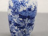 a blue and white vase sitting on a table