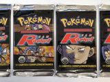 four packs of pokemon trading cards on a white surface