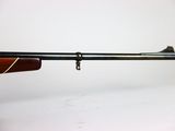 a close up of a rifle on a white background with a white background