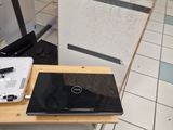 a laptop computer sitting on top of a wooden table