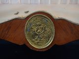 an image of a gold plate on a wooden table