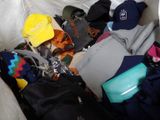 a pile of luggage sitting on a couch with a yellow hat