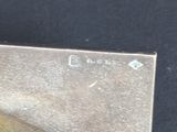 a knife that is sitting on top of a piece of metal