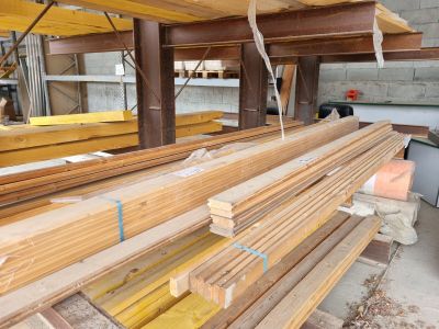 several pieces of wood are stacked on top of each other in a warehouse