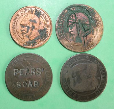 three different coins are shown on a green surface with a green background