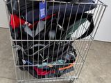 a shopping cart full of luggage sitting outside of a building