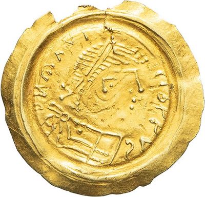 a close up of a gold coin on a white background