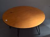 a wooden table with black hairpin legs and a brown table top