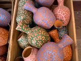 two boxes of decorative vases sitting on the floor