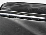 a close up of a black bag with a pen in it
