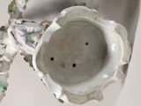a white vase that has a bird on it