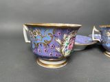 two cups and saucers are sitting on a table