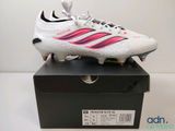 a close up of a pair of soccer shoes on top of a box