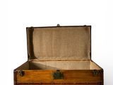 an old wooden trunk with a brown cloth inside of it