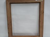 wooden picture frame with a white background and a white wall