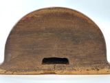 a small wooden object with a hole in it