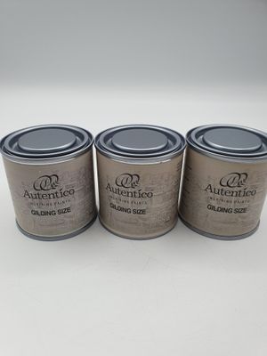 three tins of paint sitting on top of a white table