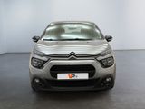 the front of a silver citrole parked in a white room