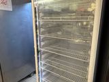 an empty refrigerator in the middle of a kitchen