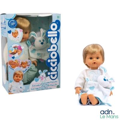 a baby doll that is sitting next to a box