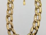 a gold chain necklace with a lock on a white background