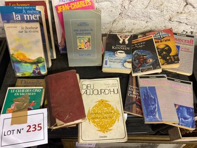 a lot of books on a table with a sign on it