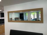 an image of a living room with a couch and a mirror
