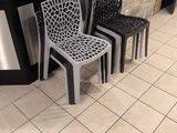 three chairs sitting in front of a counter in a restaurant