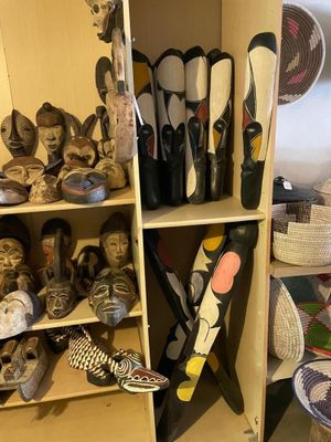 many pairs of skis and ski poles on a shelf